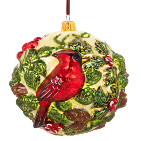 Golden ball ornament with holly, pinecones and a red cardinal