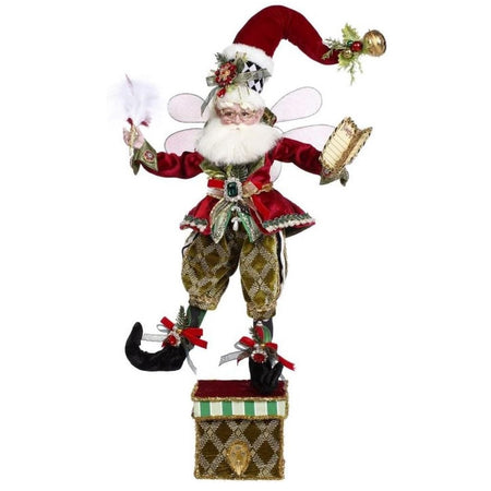 Stocking holder featuring a Mark Roberts fairy in green pants, red jacket and hat, holding a feather quill in one hand and a naughty or nice list in the other.