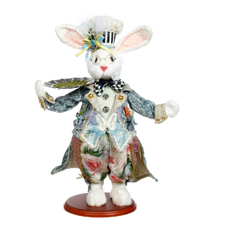 white rabbit figurine wearing colorfu suit , chef's hat and holding a servers tray.