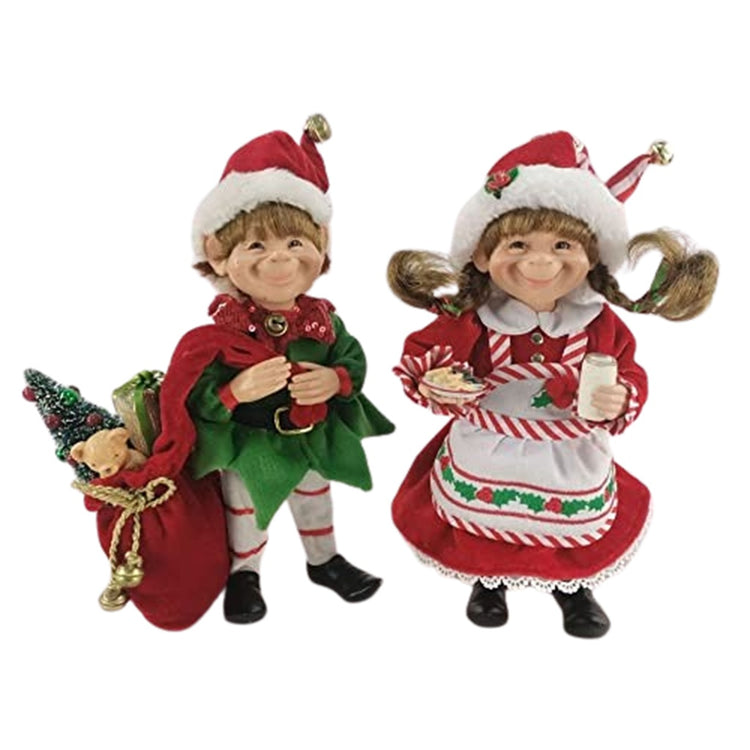 2 elf figures. one boy one girl. The boy carries a sack of presents with a tree and the girl carries a plate of cookies and a glass of milk. Both wearing traditional santa hats.