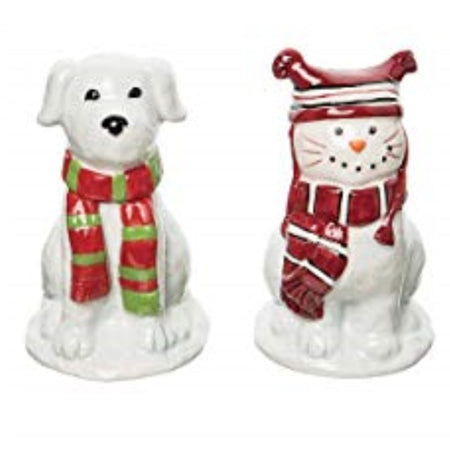 White cat and dog shaped salt and pepper shakers. Both wearing winter scarbes and the cat is wearing a 