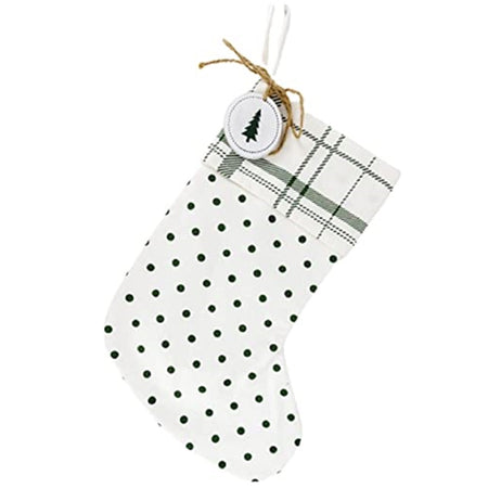 White stocking with green and white polka dot pattern, with a green and white plaid cuff. There is also a wood charm with a printed tree