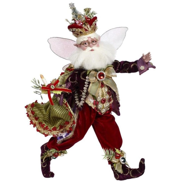 Decorative fairy figure with red pants, gold accents, and a crown on a white background