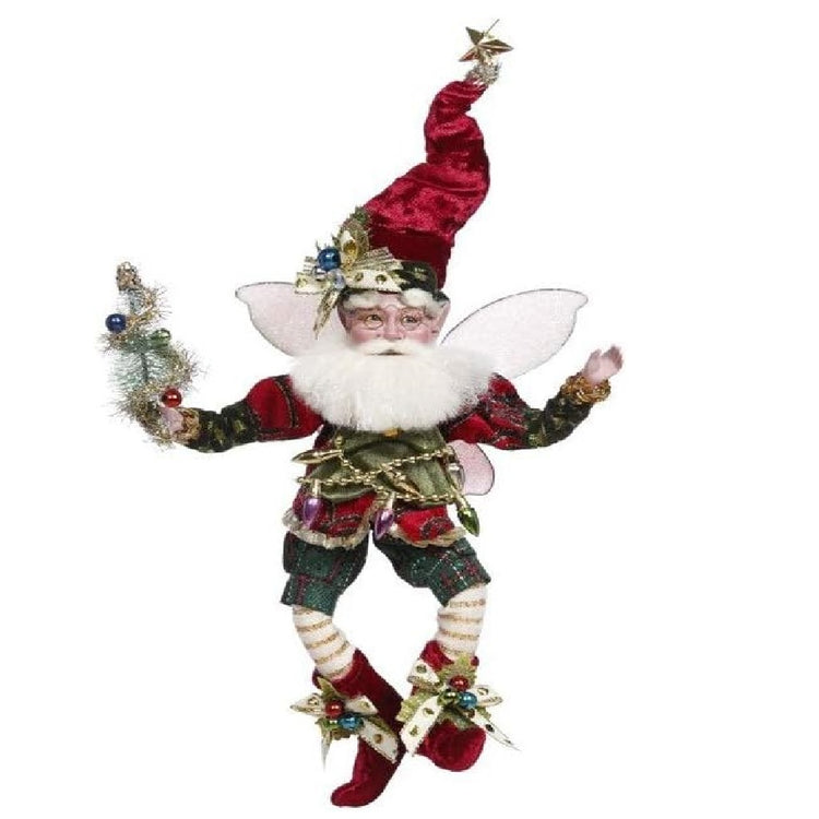 bearded fairy in dark green and red outfit, a red stocking cap and christmas lights, he's holding a decorated bottle brush tree.