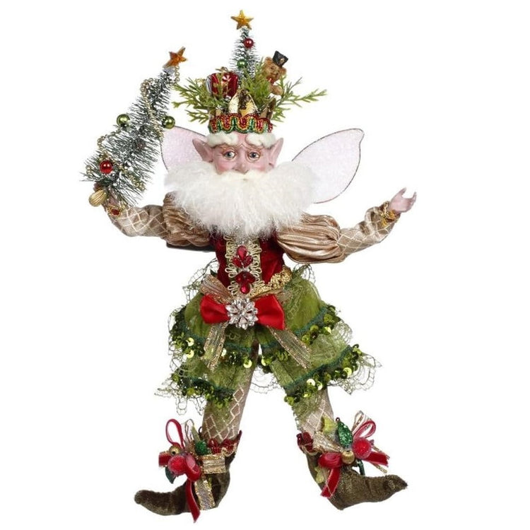 bearded fairy in gold and green outfit, with a christmas tree hat and holding a small tree.