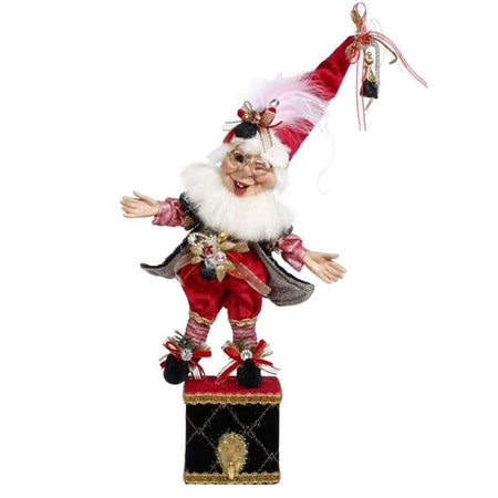 Stocking Holder made up of a Mark Roberts bearded elf in a red and black outfit with faux coal accents, standing on a box, with a hook for your stocking.