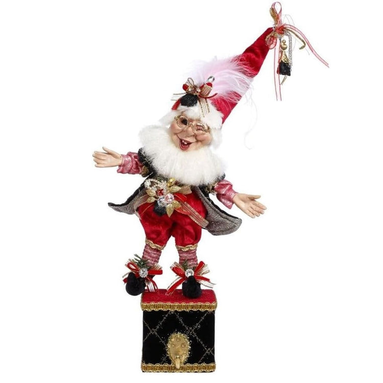 Stocking Holder made up of a Mark Roberts bearded elf in a red and black outfit with faux coal accents, standing on a box, with a hook for your stocking.