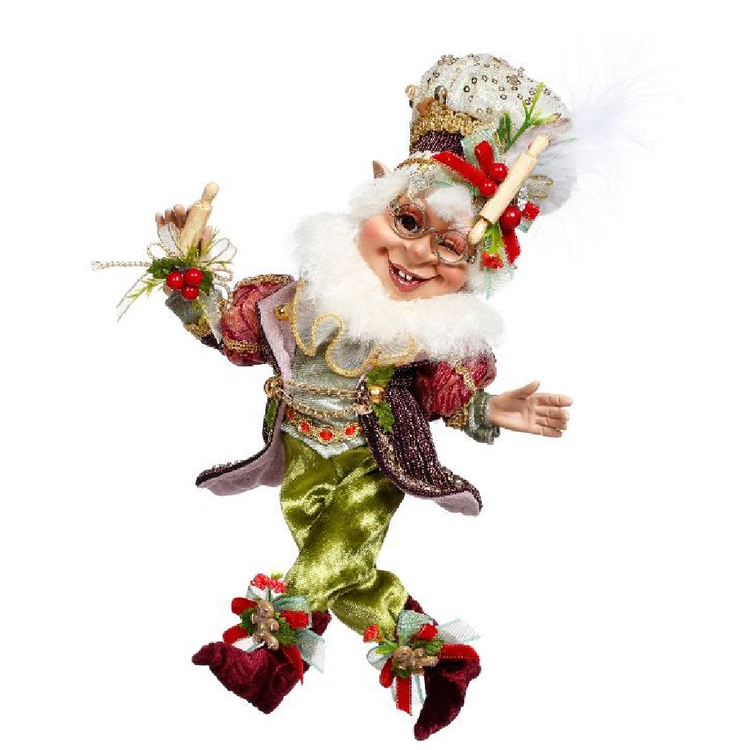 Decorative elf figurine with green, red, and white attire on a white background