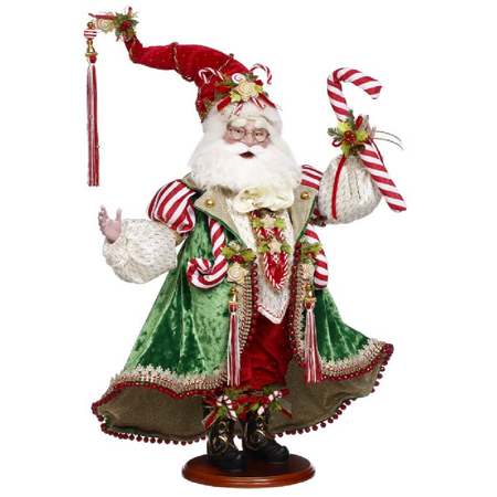 Decorative figure of a Santa Claus in festive attire with candy canes on a white background