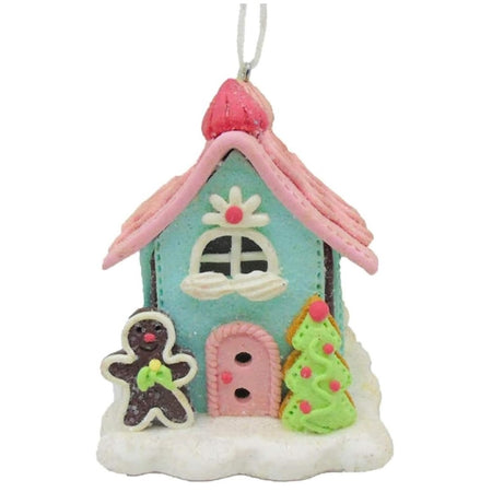 claydough style ornament of a cookie house with tree and gingerbread man, lights up with LED inside