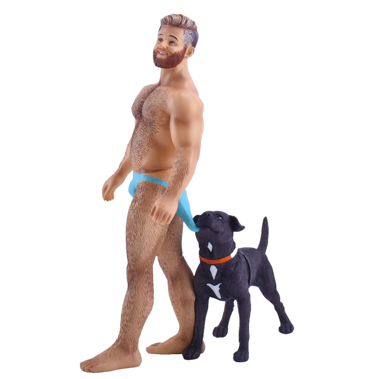 figurine of a man wearing a blue speedo, a black lab pulling it down in the back.