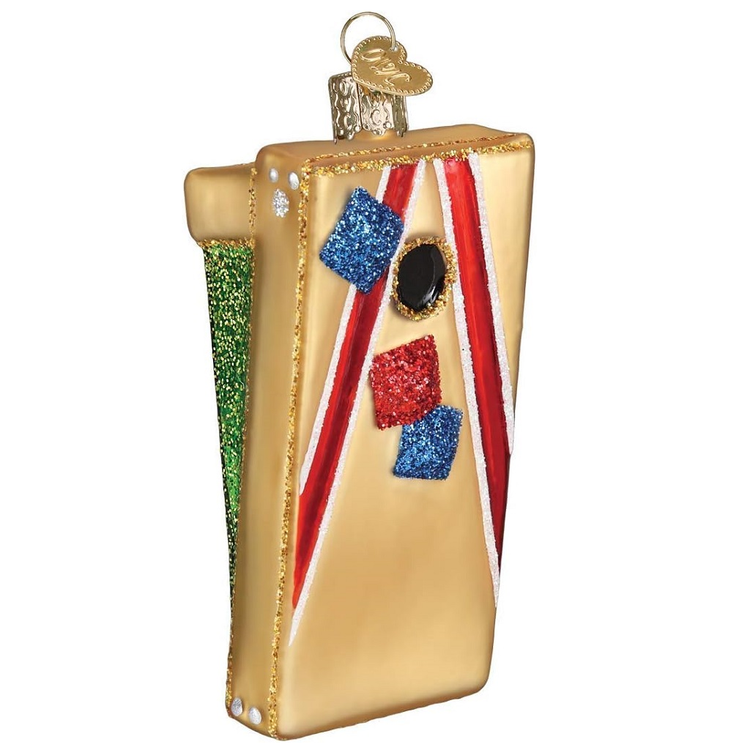 blown glass ornament of a corn hole board with blue and yellow corn hole bags.