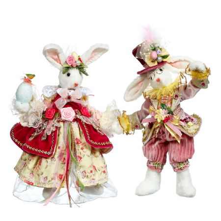 mr. and mrs. cotton tail rabbit figurines, dressing in pink and red suit and gown.