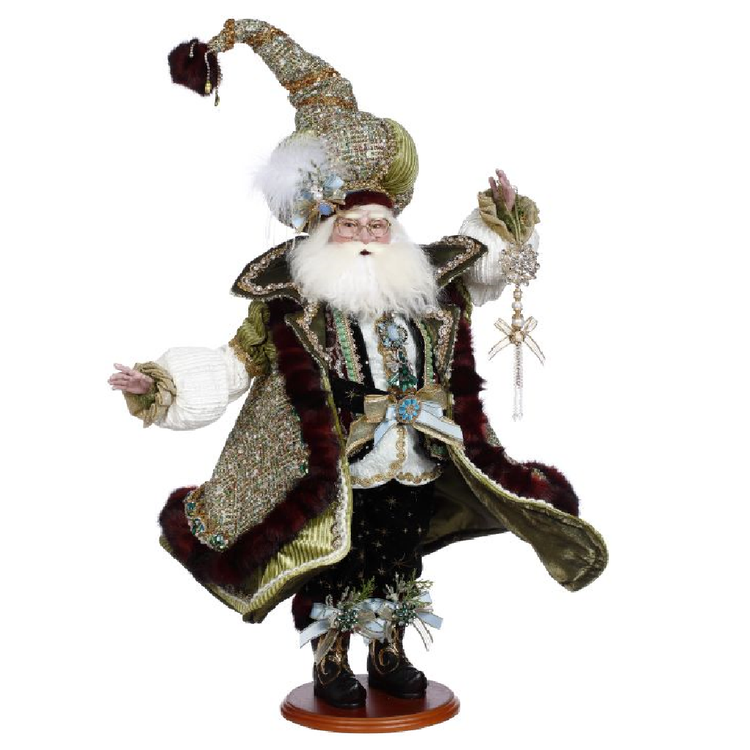 santa wearing glittery jacket lined with green velvet and matching hat, holding a rhinestone and ribbon ornament.