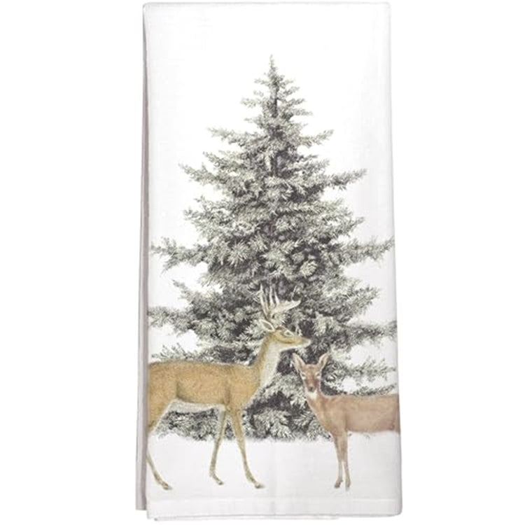 Folded white kitchen towel with an evergreen tree and 2 deer in front.