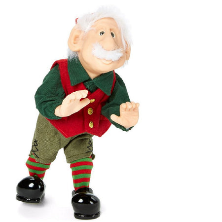 Standing elf figurine wearing a green long sleeve shirt, a red vest, tweed pants and red and green striped socks. Black elfin shoes.  He has white hair and a matching mustach