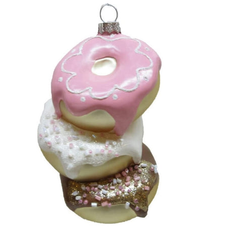 blown glass ornament that looks like a stack of three donuts, one with brown icing, one with white and one with pink.