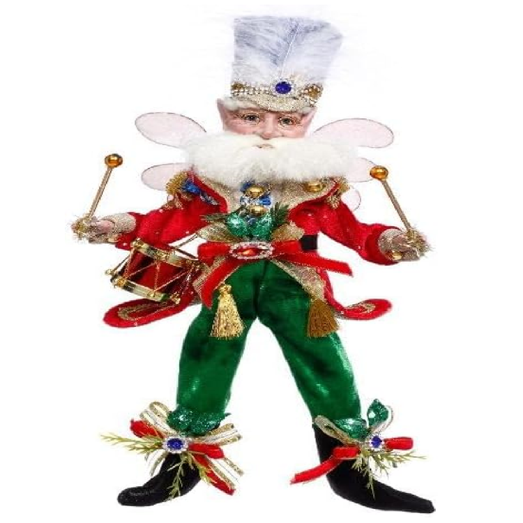 Decorative Christmas fairy figurine with green pants, red jacket, and white hat on a white background