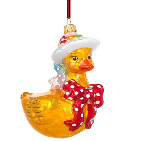 A yellow duck ornament wearing a white floral hat and a red polka-dot bow, hanging against a plain white background.