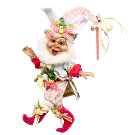 Bearded elf figurine wearing spring color suit and a stocking cap with bunny ears, outfit is adorned with easter egg accents.