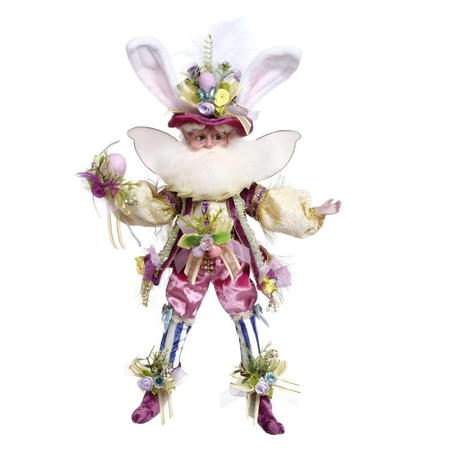 Decorative fairy figurine with floral accents on a white background