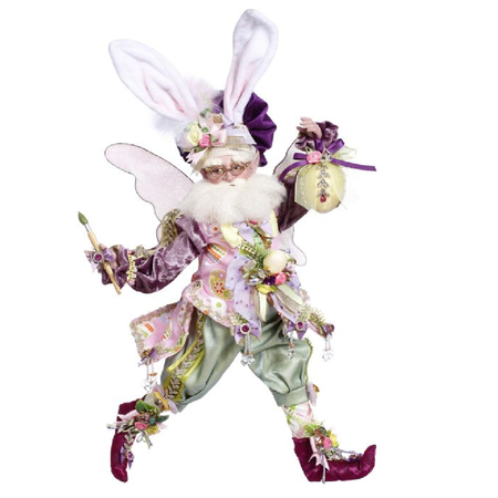 Bearded fairy wearing easter bunny ears, a easter egg patterned vest, holding a paint brush in one hand and a painted egg in the other.