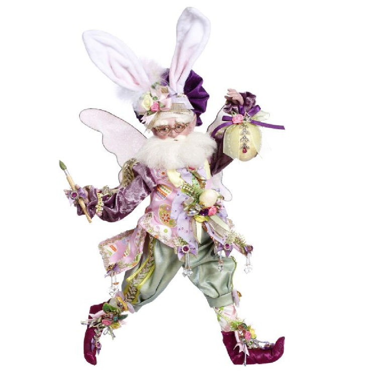 Bearded fairy wearing easter bunny ears, a easter egg patterned vest, holding a paint brush in one hand and a painted egg in the other.