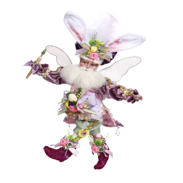 bearded fairy wearing hat with easter bunny ears, lavender color jacket, and holding a paint brush.