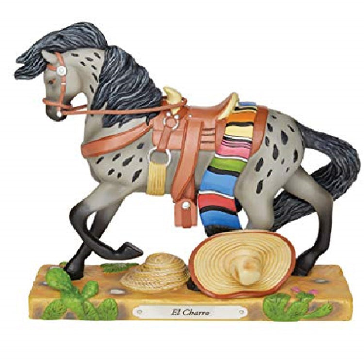 Grey galloping horse on a wood stand with a metal name tag El Charro.  folded mexican style blanket, rope and sombrero at.