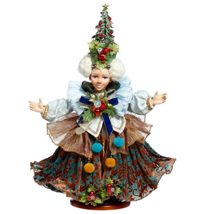 Figurine of a female elf wearing colorful dress, and a hairstyle of buns with a christmas tree atop her head.