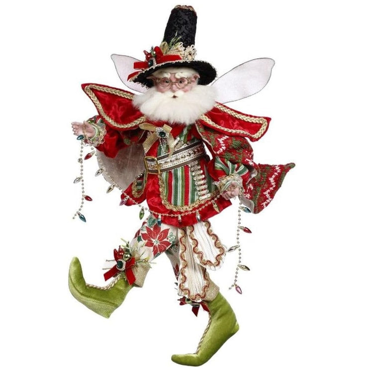 bearded fairy wearing red and green outfit, with poncho, a black hat and holding a string of faux christmas lights.