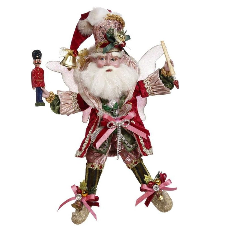 Decorative figure of a fairy in a festive outfit with red and gold accents on a white background