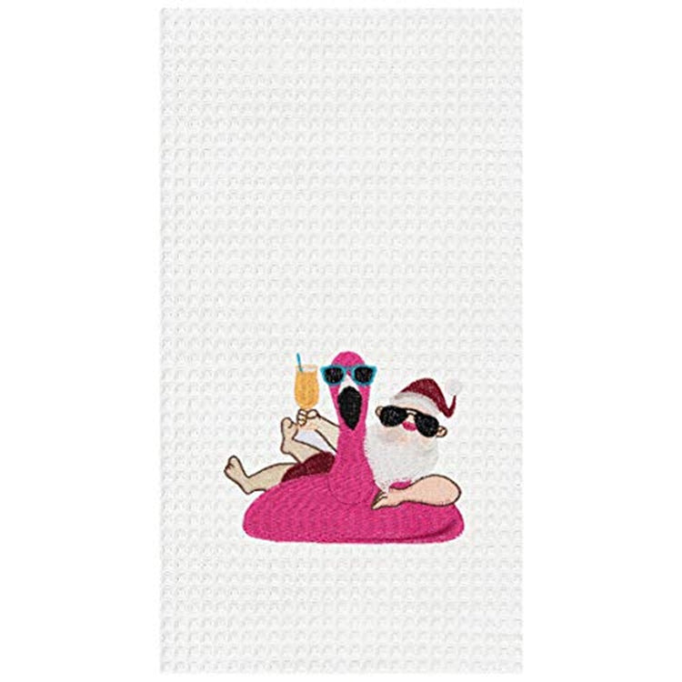 white towel with an embroidered pink flaming pool foat and santa floating in it holding a tropical drink.