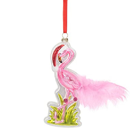 Standing Flamingo shaped hanging ornament on red ribbon. The flamingo wears a Santa hat, stands in grass and has a pink feathered tail.