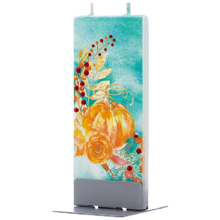 flat candle on metal stand.  Candle is white with spray paint look in teal background with orange pumpkin matching color flower leaves and berries. 2 wicks