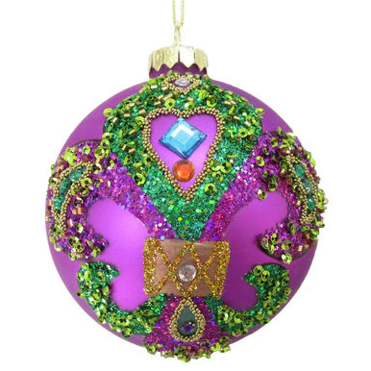 Purple round ornament with purple and green glitter in the shape of a Fleur Di Lis
