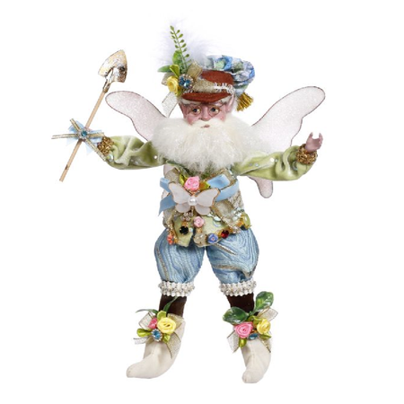 bearded fairy in light blue and green outfit, shoes and hat have flower accents, and he's holding a shovel.