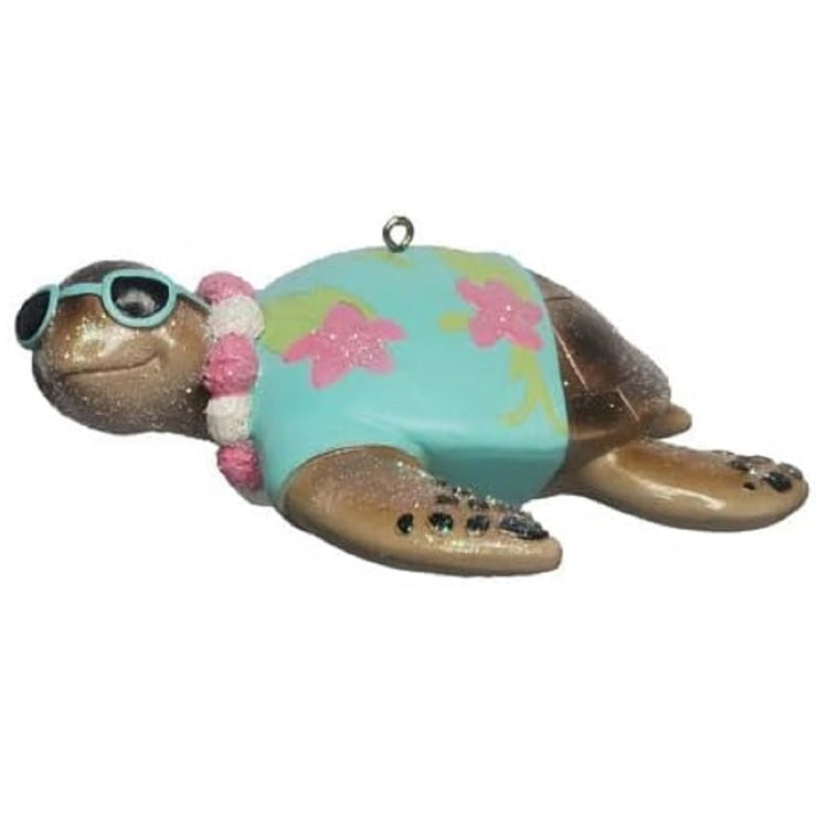 Resin sea turtle ornament with a blue and pink hawaiian  shirt and sunglasses.
