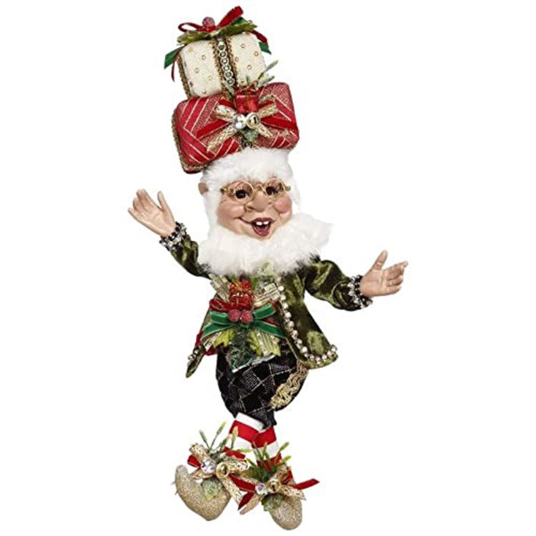 Elf figure wearing glasses and 2 wrapped presents as a hat.  Festive outfit in green and gold with ribbons and bead accents on both jacket and booties.