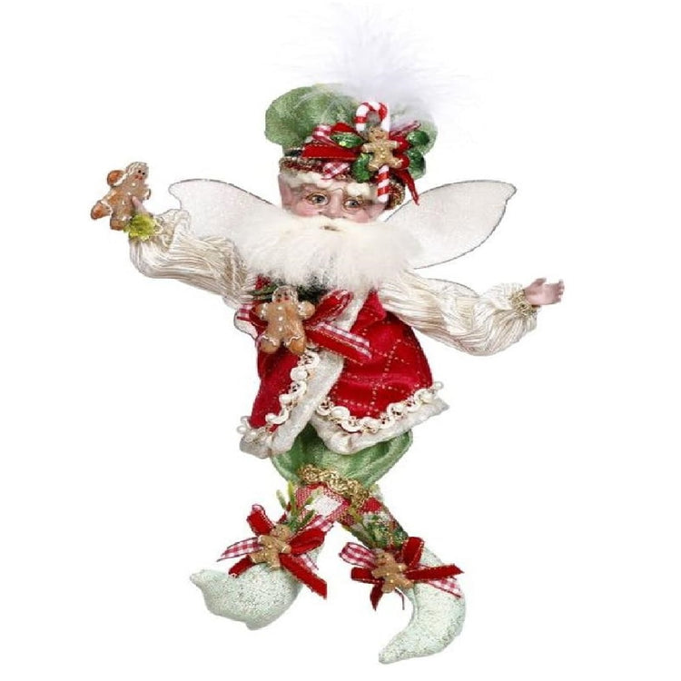 bearded fairy in a red vest, green hat and pants. his whole outfit has gingerbread man accents.