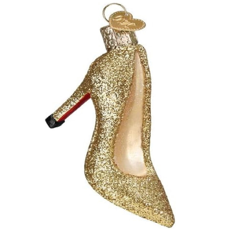 blown glass ornament of gold sparkly high heel with a red bottom.