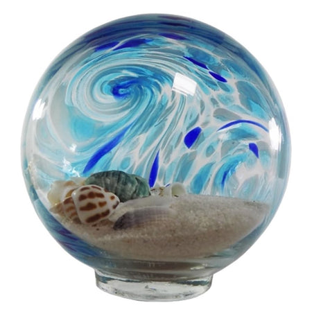 blown glass sphere with blue swirls  filled with sand and shells.