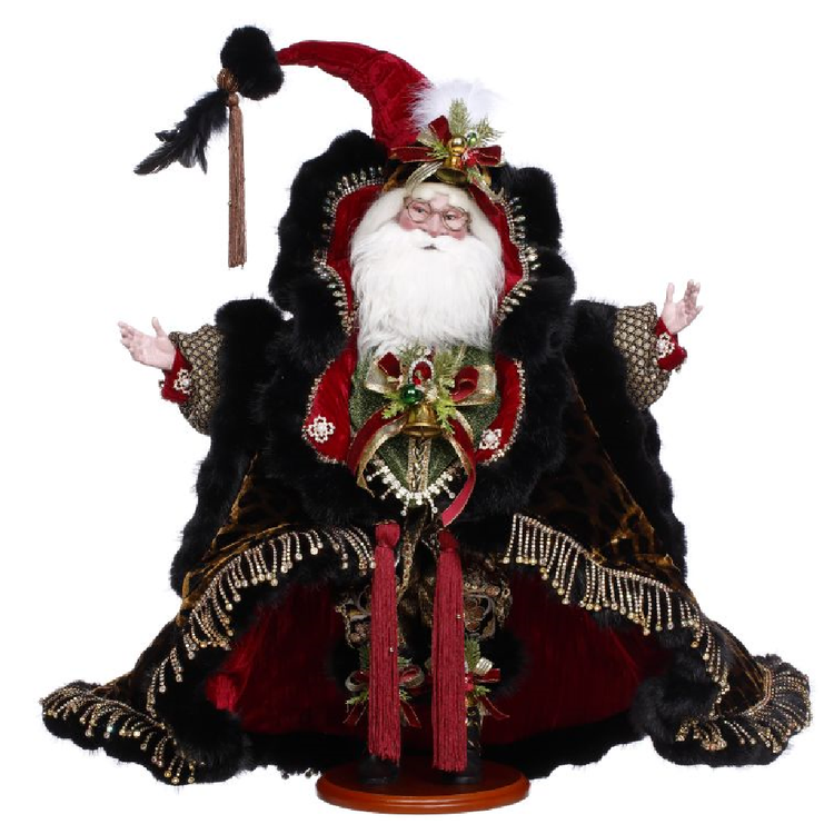 Decorative figure of Santa in a red hat and black fur coat on a white background