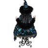 Back view of Karen Didion Glitzy Peacock Witch Figurine showing feather trim and detailed gown