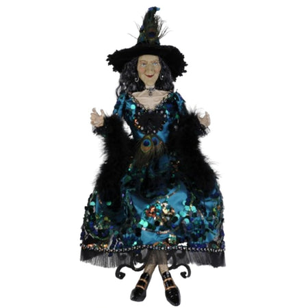 Front view of Karen Didion Glitzy Peacock Witch Figurine in teal satin gown with faux peacock feathers and rhinestone accents