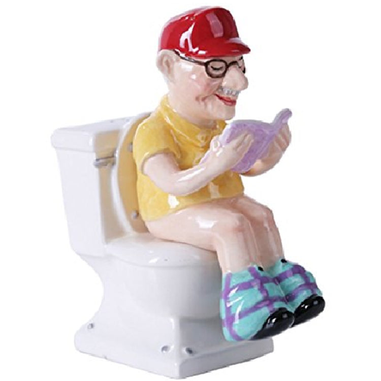 salt and pepper shakers designed like a white toilet with grandpa reading while sitting on the toilet.  red hat