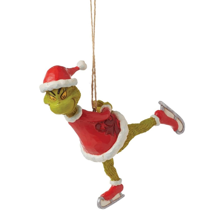 Ornament of the Grinch in a red outfit and Santa hat ice skating on a white background