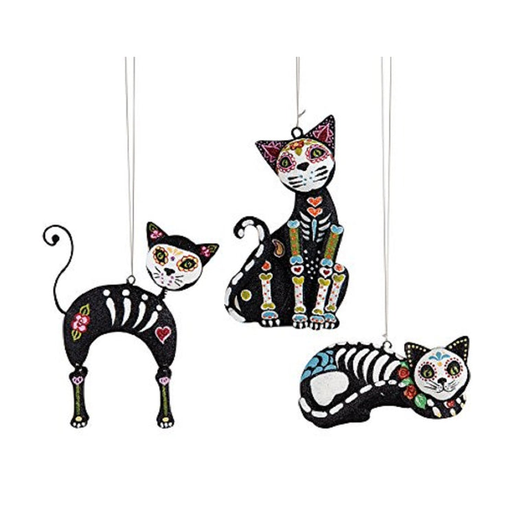 3 cat ornaments painted like Day of the Dead in skulls with white faces.