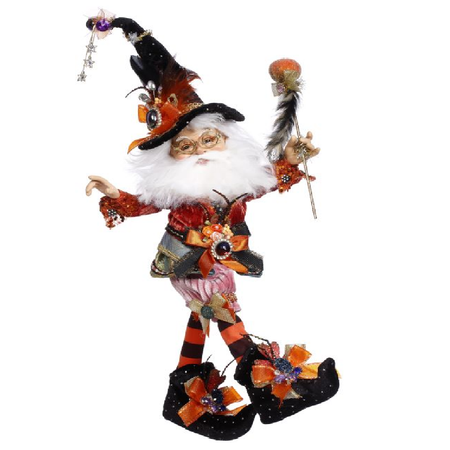 Elf with white beard, black and orange outfit and a witches hat.