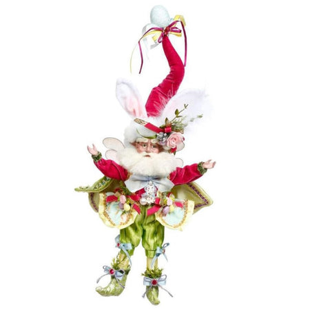 Bearded fairy wearing pint jacket and hat, green pants, and all adorned with easter eggs. Hat has bunny ears.